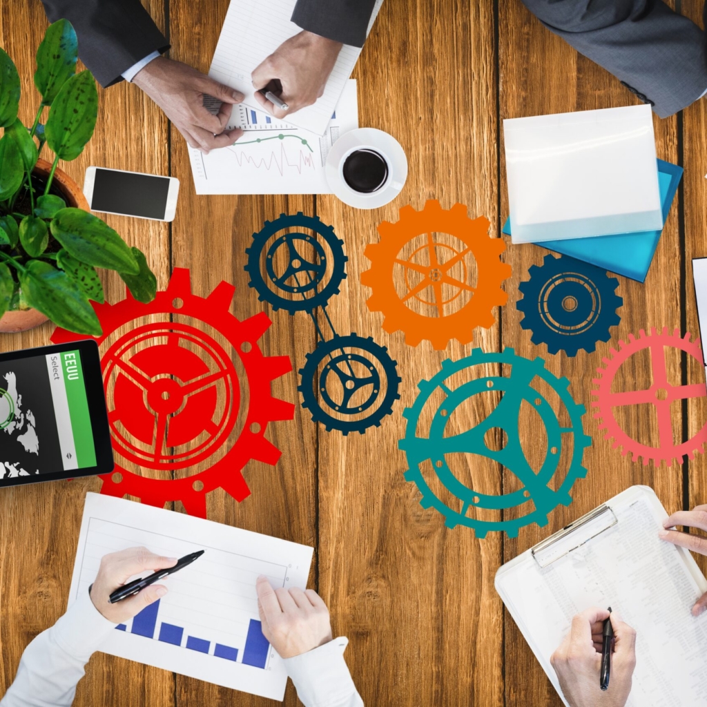 digital composite of hands using notebooks and devices on desk background