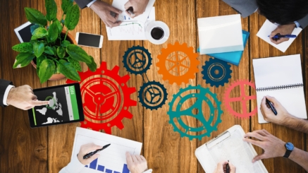 digital composite of hands using notebooks and devices on desk background