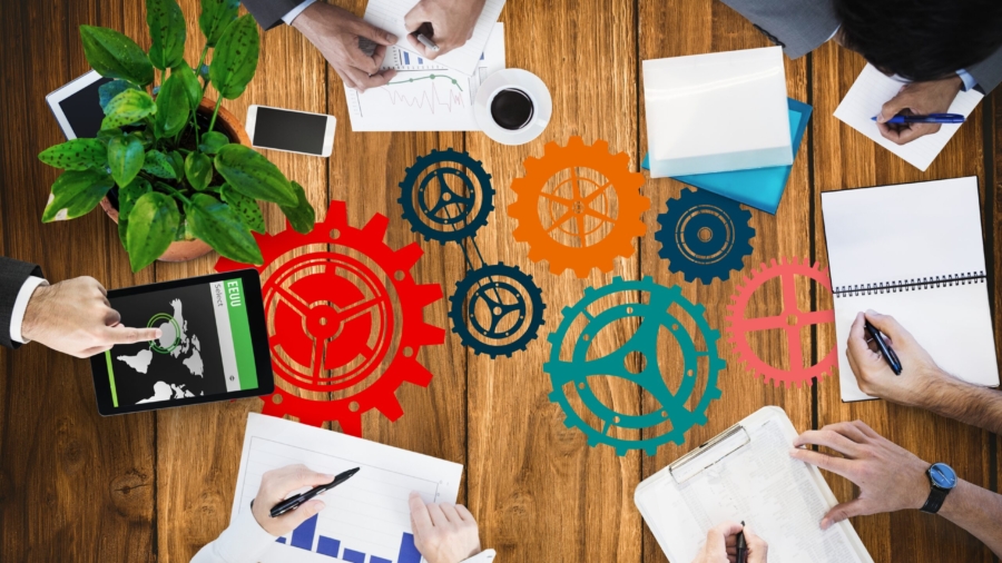 digital composite of hands using notebooks and devices on desk background